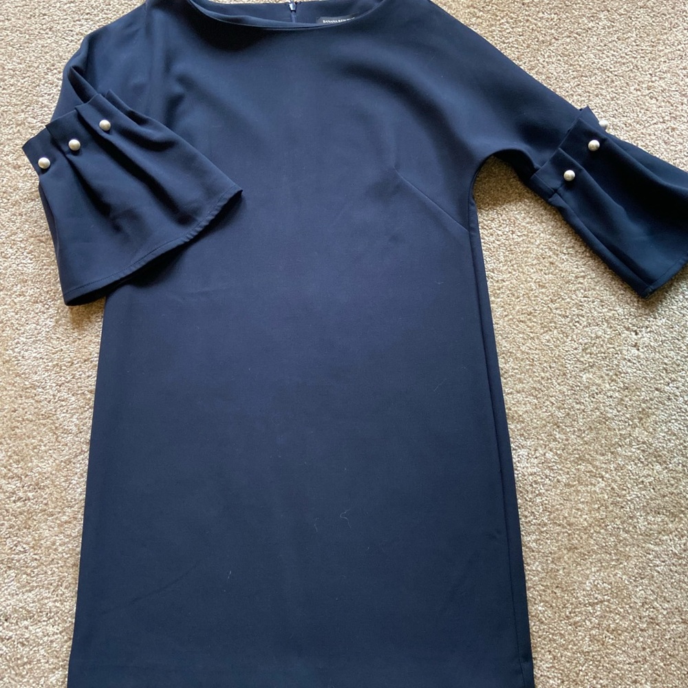 Navy dress with 3/4 sleeve. Poly with some spandex. Just above knee length